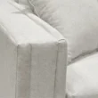 Upholstered sofa armrest close view.