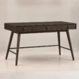 Angled front view of Script Trestle Writing Desk in Walnut finish with three-drawer storage