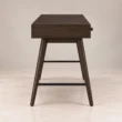 Side view of Script Trestle Writing Desk in Walnut finish showing the wooden trestle leg structure