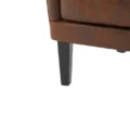 Close-up of the Crown upholstered wingback chair leg with dark wood finish and brown faux leather upholstery