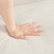 Close-up shot of a hand gently pressing into the soft fabric of the Versatile Square Arm Sofa, highlighting the cushion's comfort.