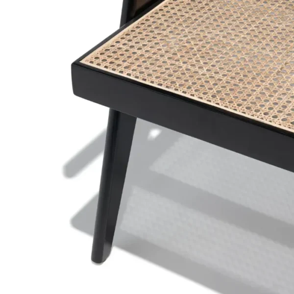 Close-up of Chaya Cane Armchair seat with woven cane detail and black wooden frame Close-up of Chaya Cane Armchair seat with woven cane detail and black wooden frame