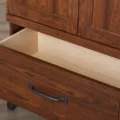 Open drawer of Cherry Forge Wardrobe showing interior storage and dark metal handle.