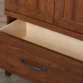 Open drawer of Cherry Forge Wardrobe showing interior storage and dark metal handle.