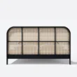 cane base of bed showing black legs