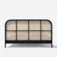 cane base of bed showing black legs