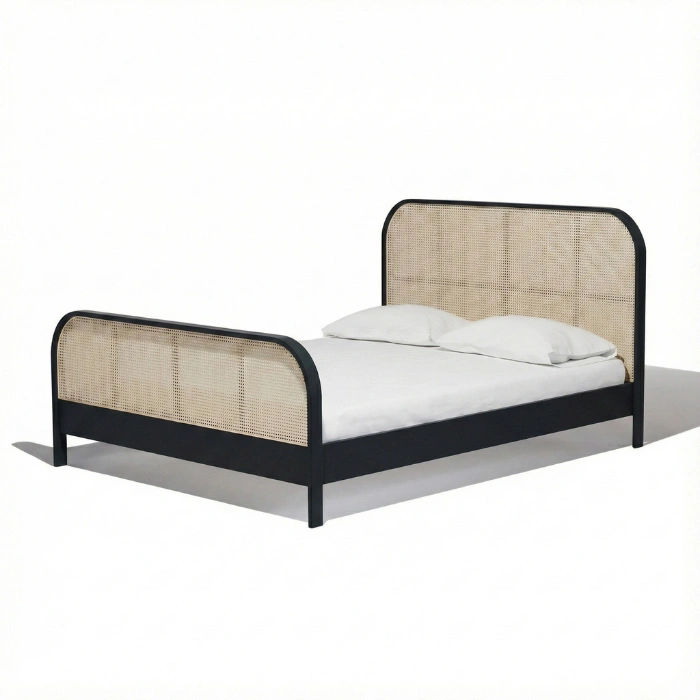 angled view of black cane bed in a white background