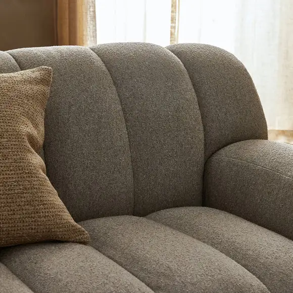 close view of grey upholstered sofa.