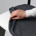 Hand adjusting removable dark grey seat cover on Roco Lisette dining chair.