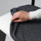 Hand adjusting removable dark grey seat cover on Roco Lisette dining chair.