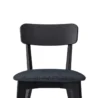 Close-up of Roco Lisette dining chair with curved black backrest and cushioned dark fabric seat.