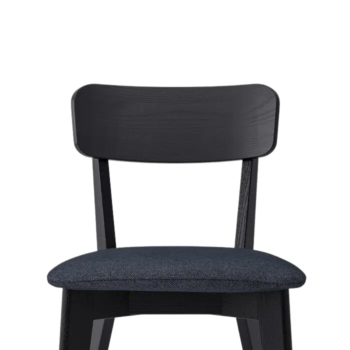 Close-up of Roco Lisette dining chair with curved black backrest and cushioned dark fabric seat.