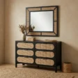 Black dresser in a modern room with matching mirror