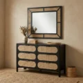Black dresser in a modern room with matching mirror