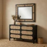 Black dresser in a modern room with matching mirror