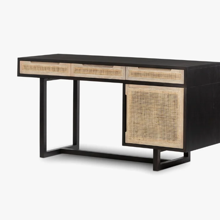 Delilah Cane Desk with black wood frame, three drawers, and cane storage cabinet