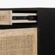 Close-up of Delilah Cane Desk drawer with black metal slide mechanism and natural cane detailing