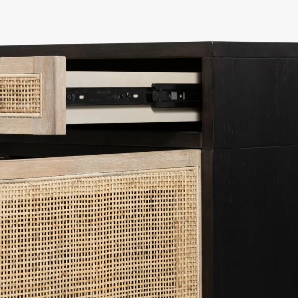 Close-up of Delilah Cane Desk drawer with black metal slide mechanism and natural cane detailing Close-up of Delilah Cane Desk drawer with black metal slide mechanism and natural cane detailing