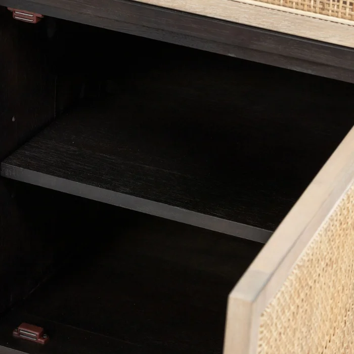 Open storage cabinet of Delilah Cane Desk with black wood interior and natural cane panel door