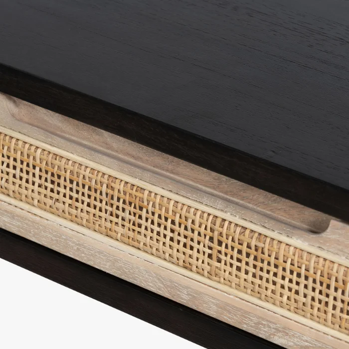 Close-up of Delilah Cane Desk drawer with woven cane panel and black wood top