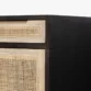 Close-up of Delilah Cane Desk featuring black wood finish and natural woven cane drawer panel