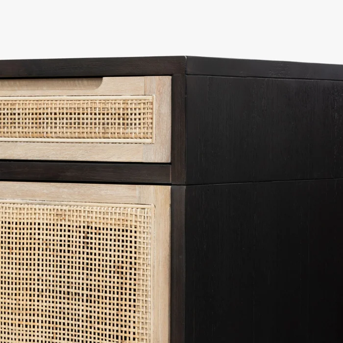 Close-up of Delilah Cane Desk featuring black wood finish and natural woven cane drawer panel