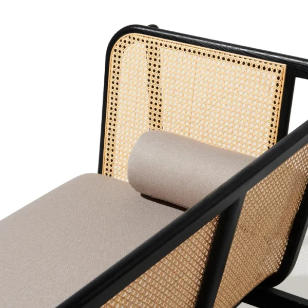 Side view of black cane sofa with handwoven rattan panels, beige cushion, and a solid wood frame Side view of black cane sofa with handwoven rattan panels, beige cushion, and a solid wood frame