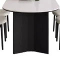 Base detail of Orbis Dining Table with curved black support and rounded top