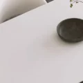 Close-up of Orbis Dining Table surface with decor bowl