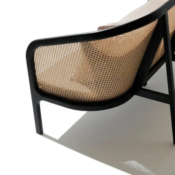 Elaila Cane Sofa – Close-up of cane backrest with black wooden frame and cushions Elaila Cane Sofa – Close-up of cane backrest with black wooden frame and cushions