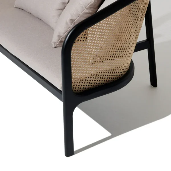 Elaila Cane Sofa – Side view of black frame cane sofa with beige cushions Elaila Cane Sofa – Side view of black frame cane sofa with beige cushions