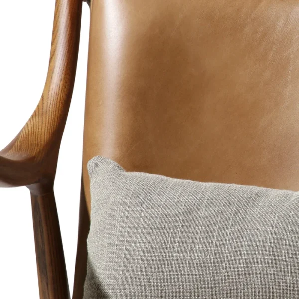 Close-up of Incurve Leatherite Chair – Brown leatherite seat with a wooden frame and cushion Close-up of Incurve Leatherite Chair – Brown leatherite seat with a wooden frame and cushion