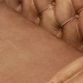Close-up of brown Lavender Pure Leather Sofa with tufted backrest and smooth seat cushion.