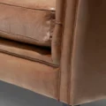Close-up of brown Lavender Pure Leather Sofa corner with soft cushions and detailed stitching