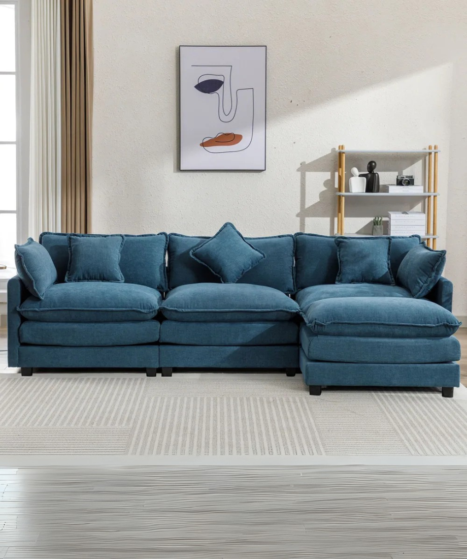 Amore Upholstered Sofa in a luxury living room setting, featuring a spacious, modern design with premium fabric upholstery, perfect for elegant homes in Pakistan and the UAE.