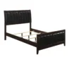 wooden bed with upholstered headboard showing wooden slats