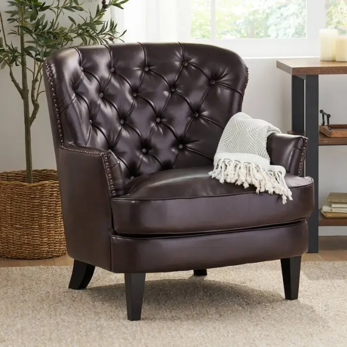 Saville Leather Club Chair with button-tufted back, metallic studded accents, and bonded leather upholstery for luxury interiors in Pakistan and UAE.