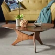 Orion Table with mid-century modern design featuring a triangular wood veneer tabletop, crossed geometric base, and solid plywood legs in Pakistan.
