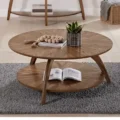Solaris round coffee table with starburst design in nutmeg brown finish, featuring a lower storage shelf, perfect for modern and premium living spaces.