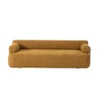 Front view of modern ochre sofa with cylindrical armrests and low, streamlined seat.