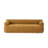 Front view of modern ochre sofa with cylindrical armrests and low, streamlined seat.