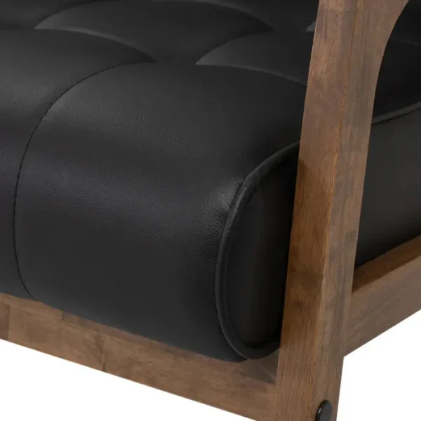 CARTER-SIFA-4-600x600 Close-up of Carter Sofa seat, tufted black upholstery with walnut frame, showcasing plush comfort.