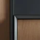 Close-up of cabinet edge showing black frame and wooden panel detail.