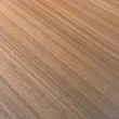 Close-up of warm wood-grain tabletop finish for a premium executive meeting table surface.