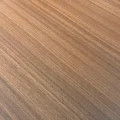 Close-up of warm wood-grain tabletop finish for a premium executive meeting table surface.