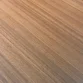 Close-up of warm wood-grain tabletop finish for a premium executive meeting table surface.