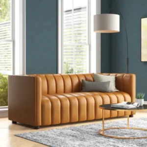 ANDERS-Sofa-Cammel-600×600 Angled view of upholstered sofa in a modern living room.