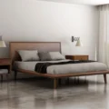 Aurora Solid Wood Bed in light walnut platform bed in a bed room