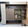 Brown wall storage unit with sliding door, open shelves, and a central display niche.