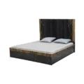 Cosmo Bed three-quarter view with channel-tufted headboard, gold geometric accents, fluted trim, and pillows